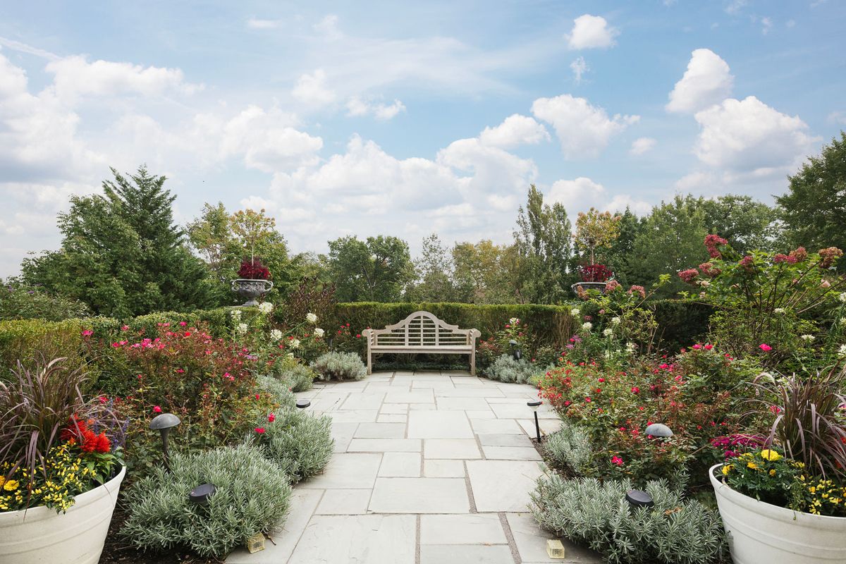 Formal garden with bluestone paving and a garden bench at 184 Upper Mountain Avenue