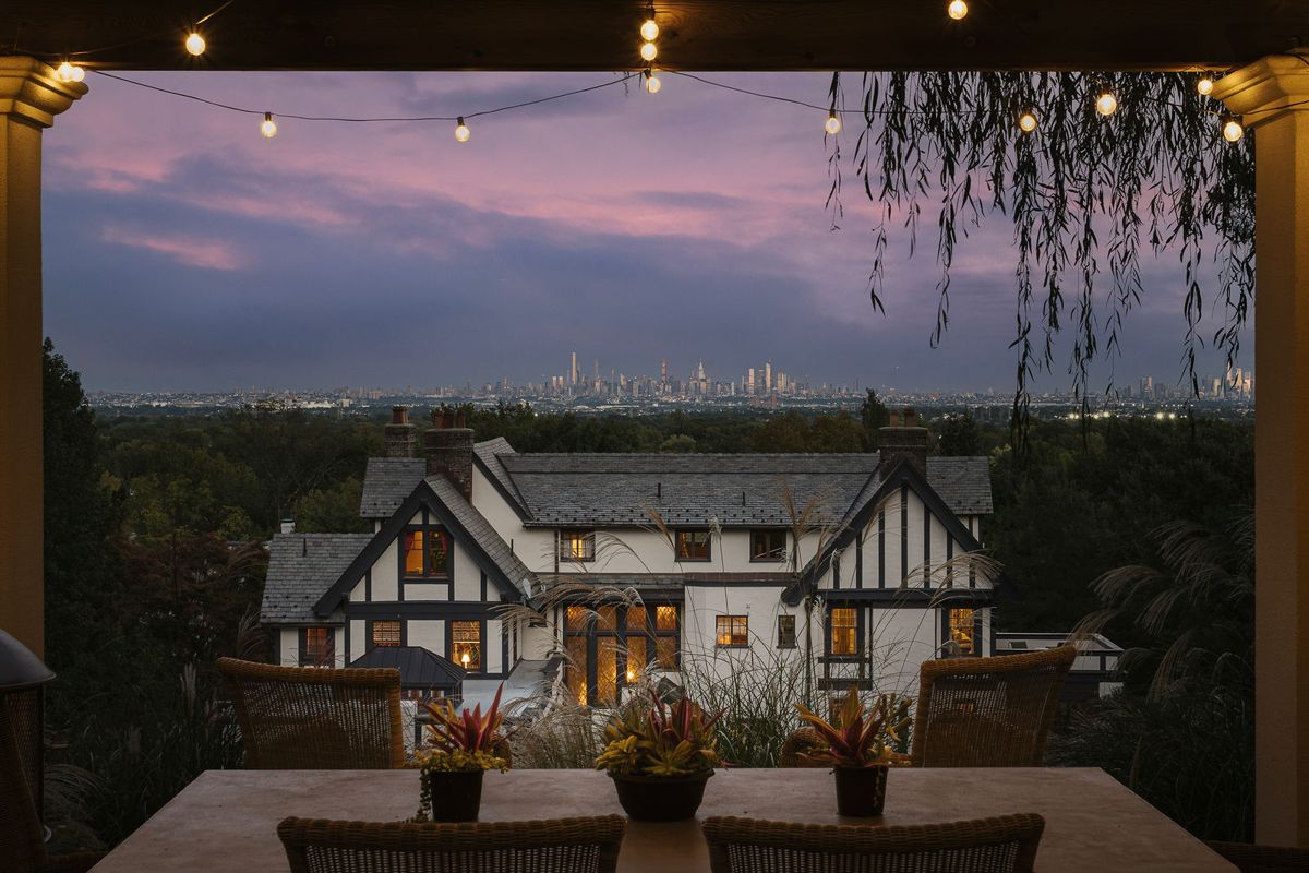184 Upper Mountain Avenue at dusk, seen from the covered dining loggia with the Manhattan skyline in the distance