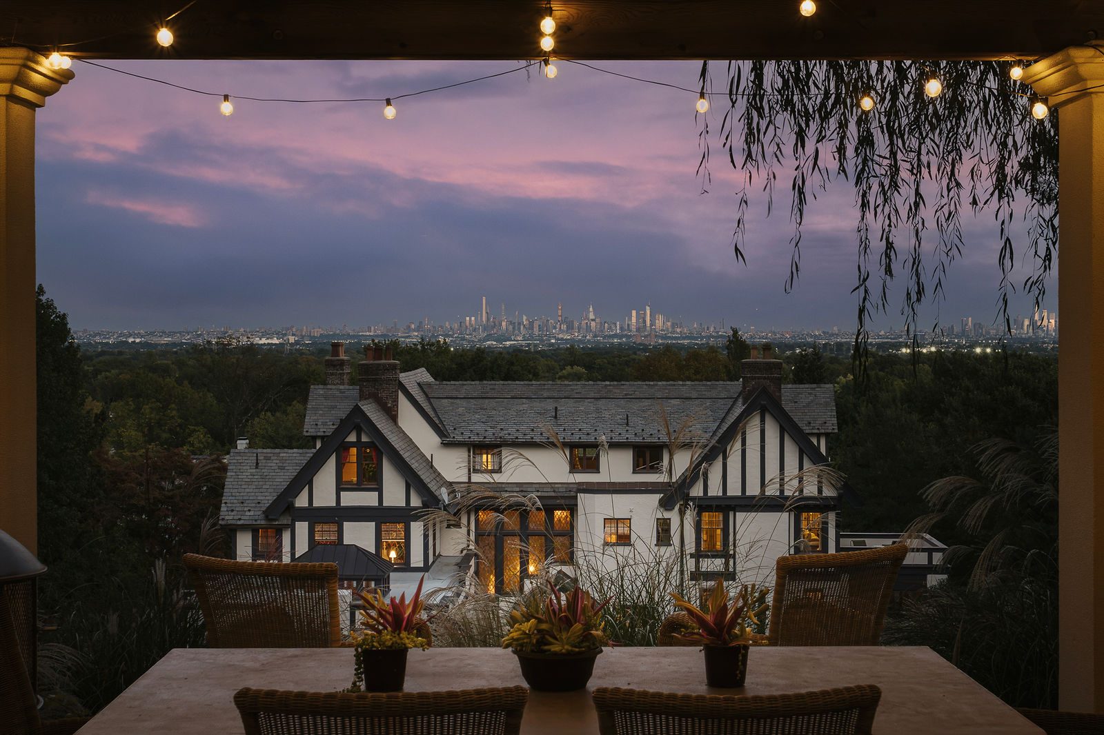 184 Upper Mountain Avenue at dusk, seen from the covered dining loggia with the Manhattan skyline in the distance