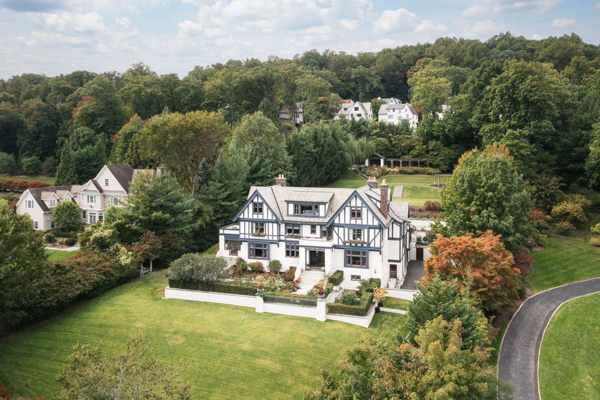 Elevated view of the curving drive and hillside lawns leading to 184 Upper Mountain Avenue