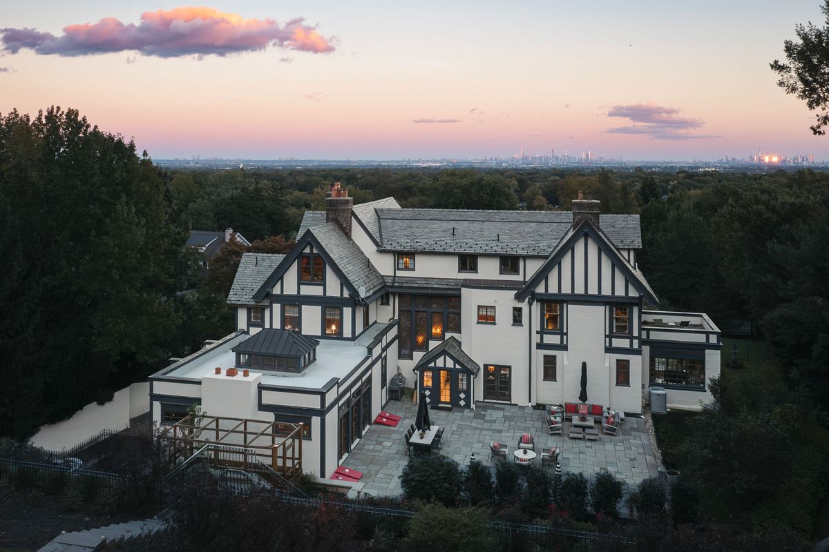 Aerial view of the rear elevation and bluestone patio at dusk, 184 Upper Mountain Avenue